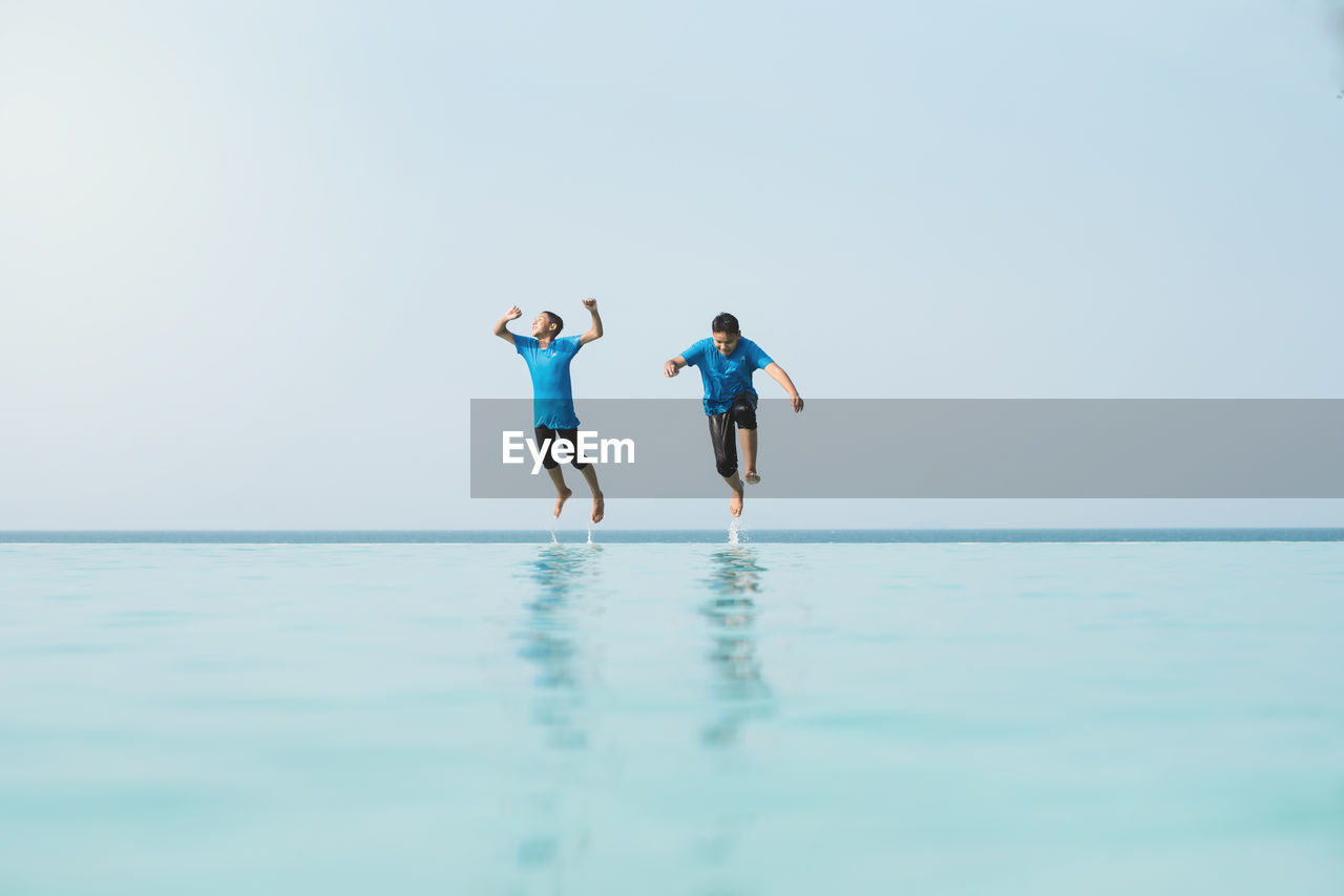 PEOPLE ON SEA AGAINST CLEAR SKY