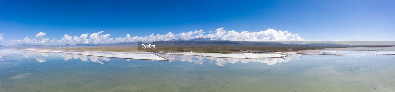 PANORAMIC SHOT OF LAKE AGAINST BLUE SKY