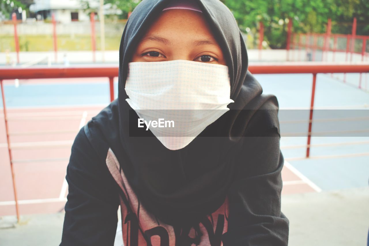 Close-up portrait of young woman wearing mask