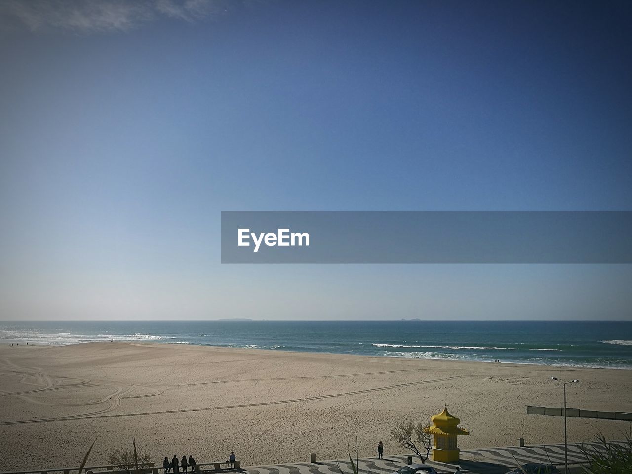 SCENIC VIEW OF BEACH AGAINST BLUE SKY