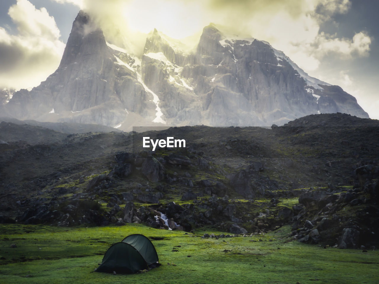 TENT ON MOUNTAIN AGAINST SKY