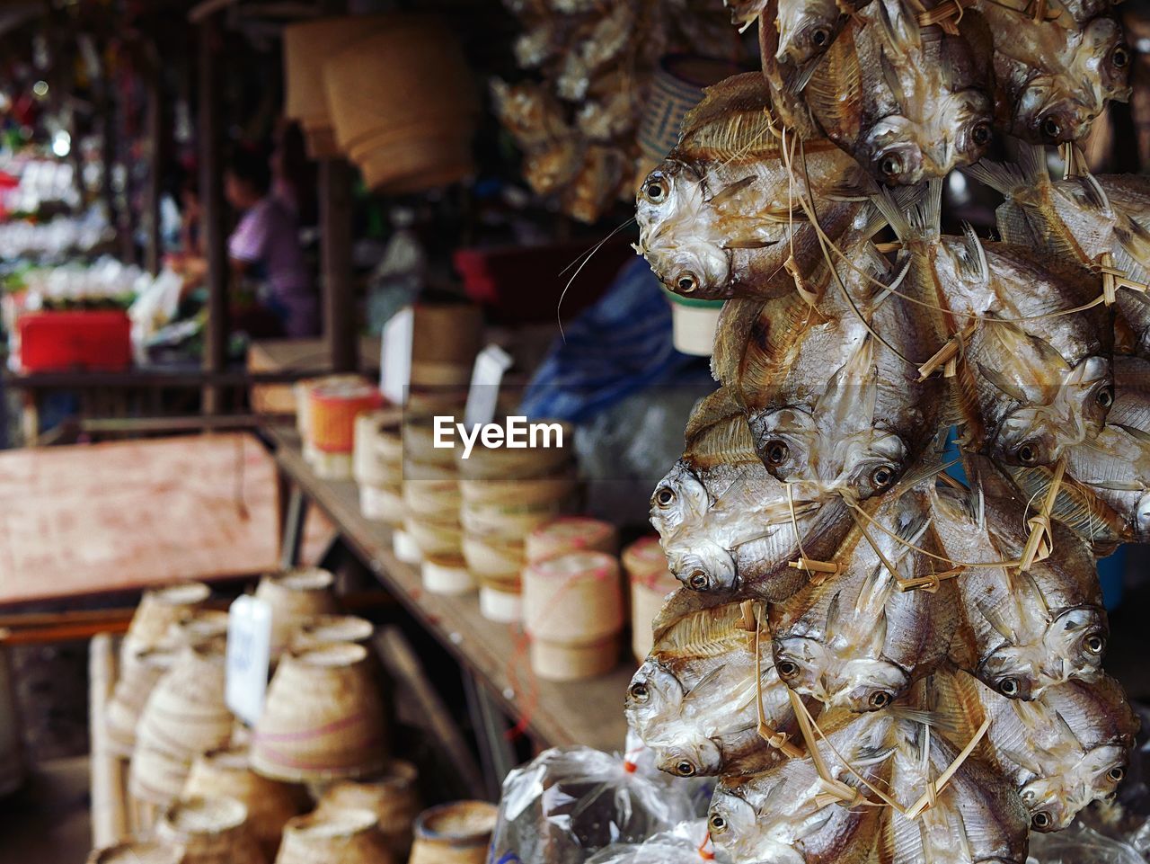Hanging dried fish for sale in market stall