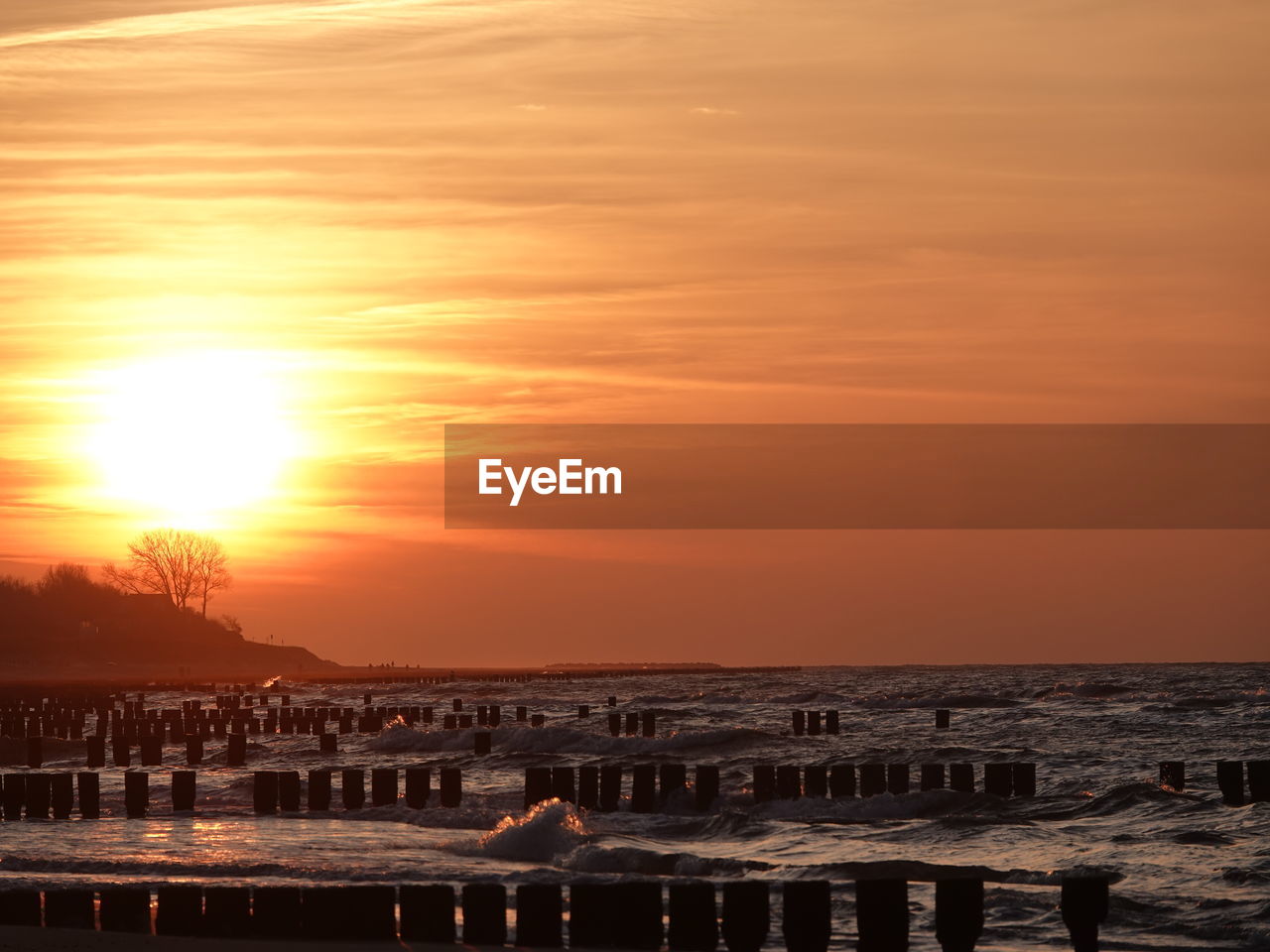 sky, sunset, water, sea, nature, beauty in nature, orange color, horizon, sun, dawn, cloud, scenics - nature, evening, tranquility, beach, architecture, sunlight, land, travel destinations, tranquil scene, idyllic, no people, reflection, outdoors, animal themes, ocean, animal, horizon over water, silhouette, built structure, travel, afterglow, environment, tourism, dramatic sky, coast, animal wildlife