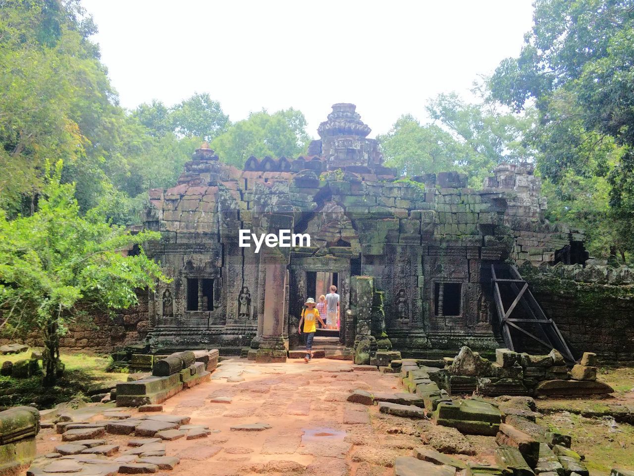 Mid distance view of tourist walking at old ruin temple
