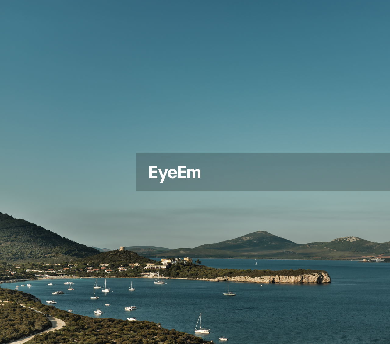 SCENIC VIEW OF BAY AGAINST CLEAR BLUE SKY