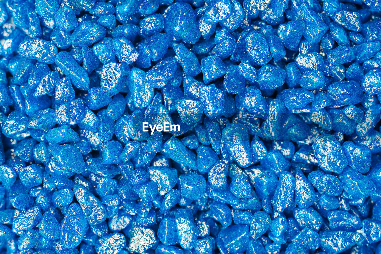 Light blue gemstone fake pattern. blue glitter stones for garden decoration, flat lay background