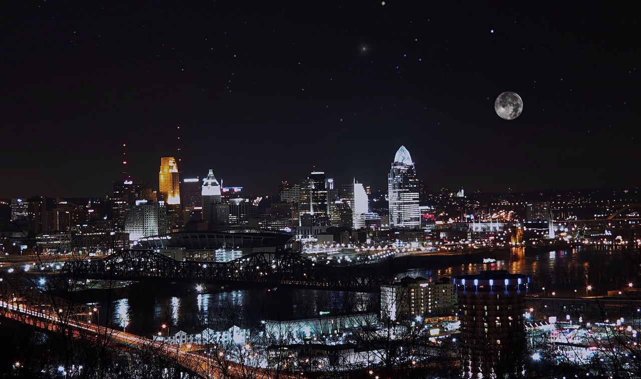 High angle view of city lit up at night