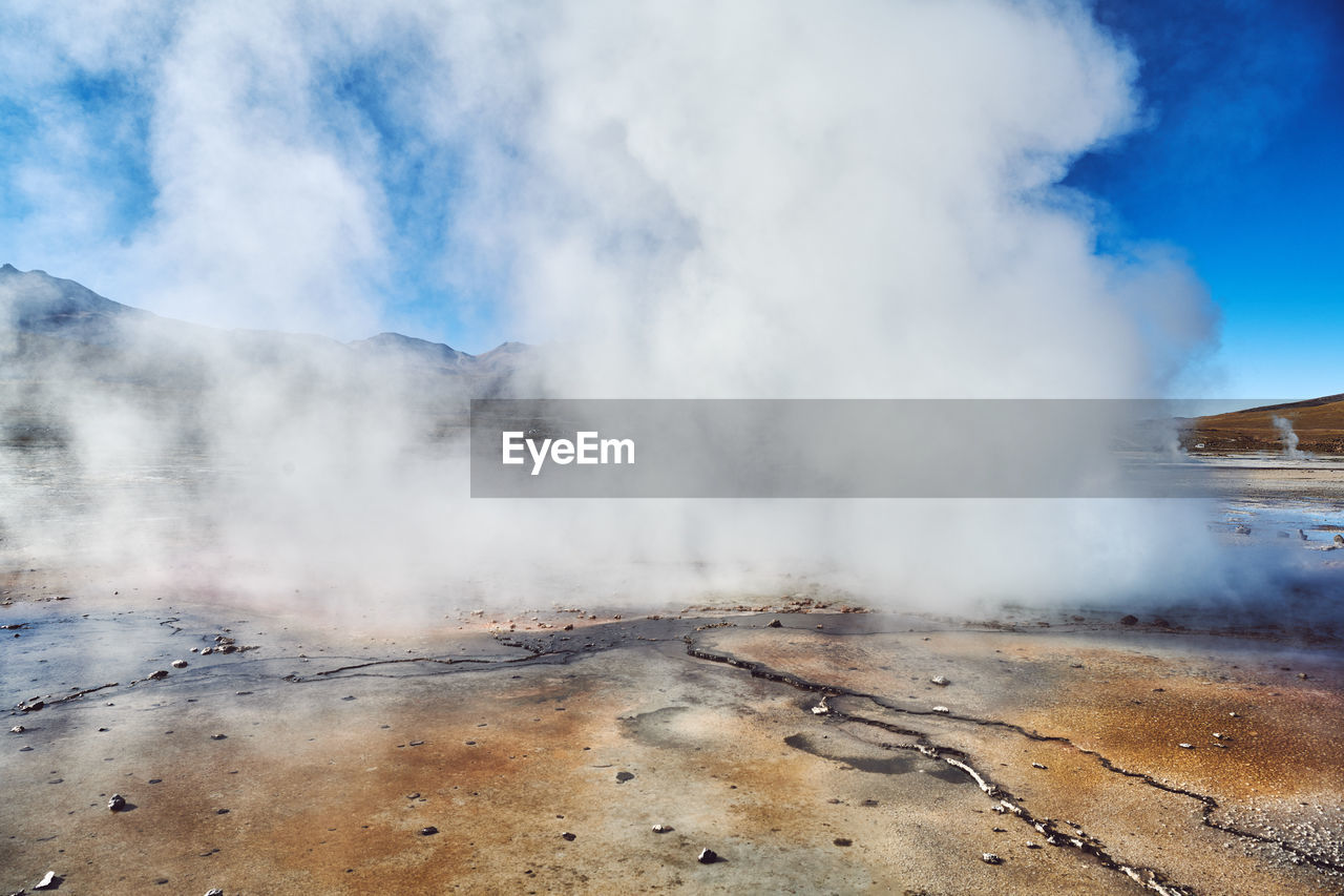 SCENIC VIEW OF SMOKE EMITTING FROM MOUNTAIN