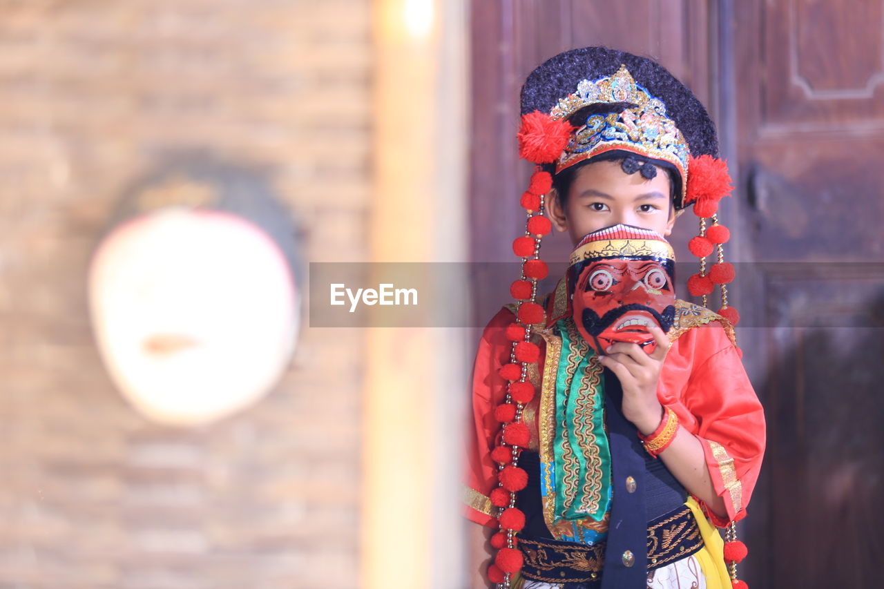 Traditional mask dancer with red costume