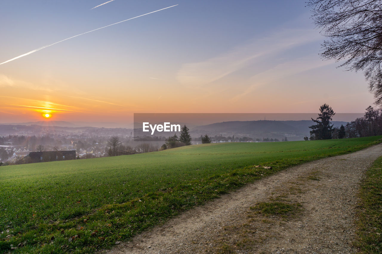 Scenic view of field against sky during sunset