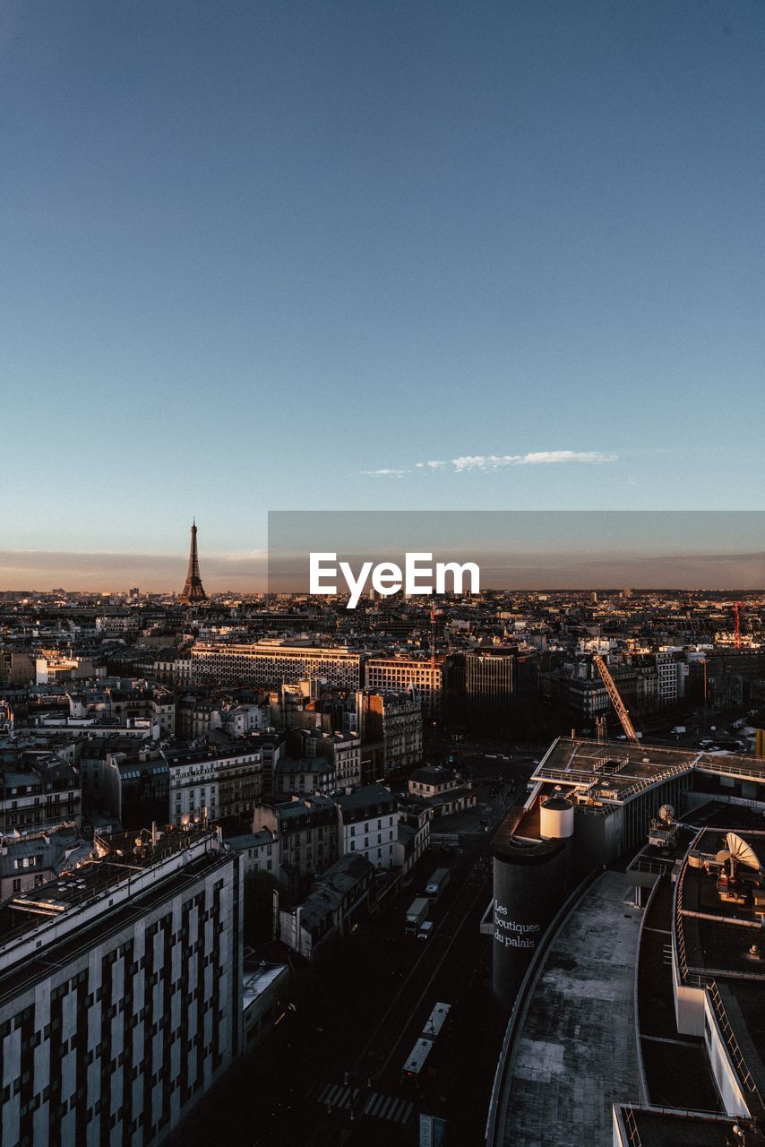 High angle view of illuminated cityscape against clear sky