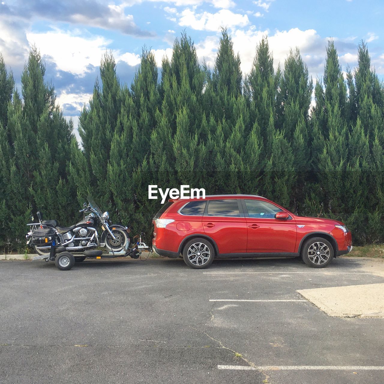 CAR ON RED ROAD AGAINST SKY