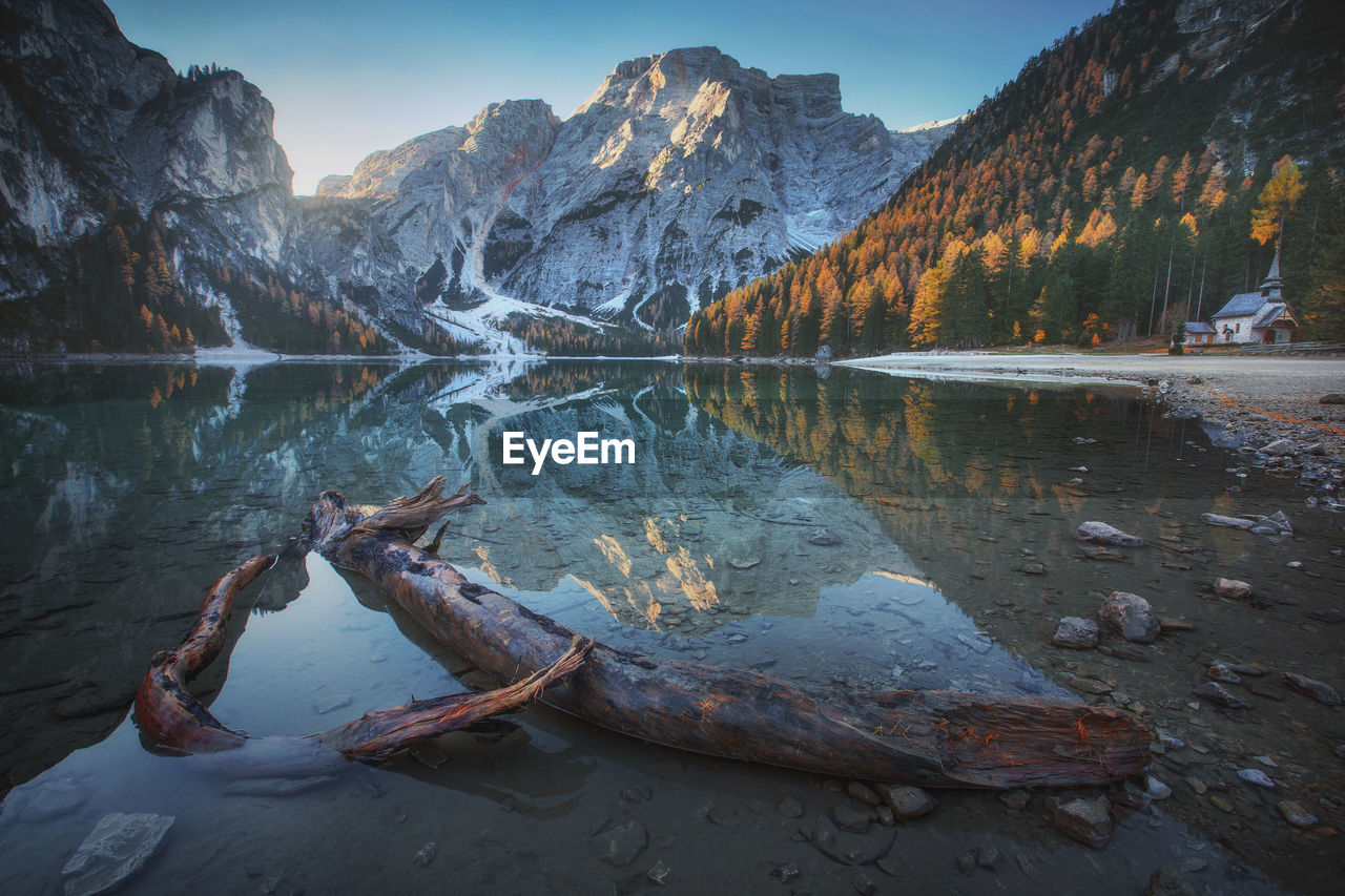 Scenic view of lake by mountains against sky