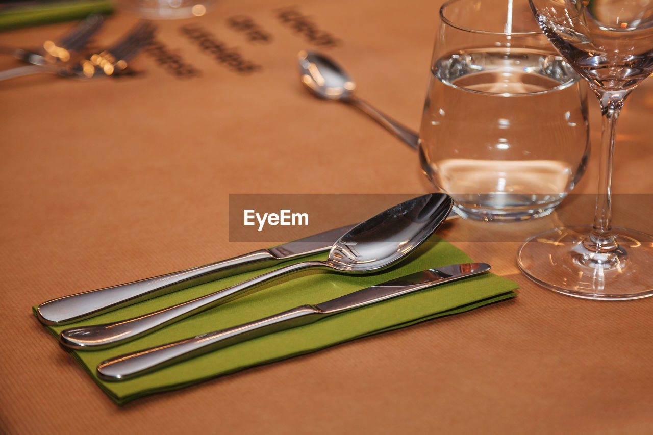 Table served in restaurant - glass of water, wine glass and cutlery 