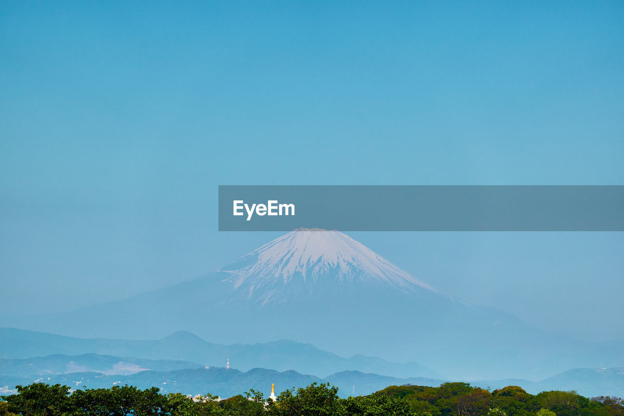 View of volcanic mountain against blue sky