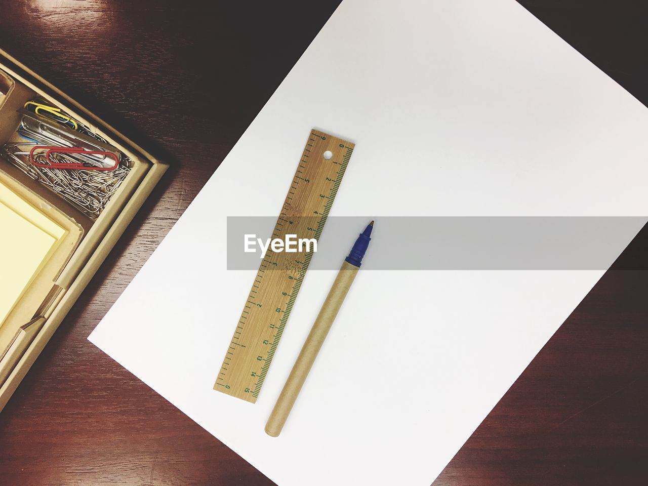 High angle view of blank paper with ruler and pen on table