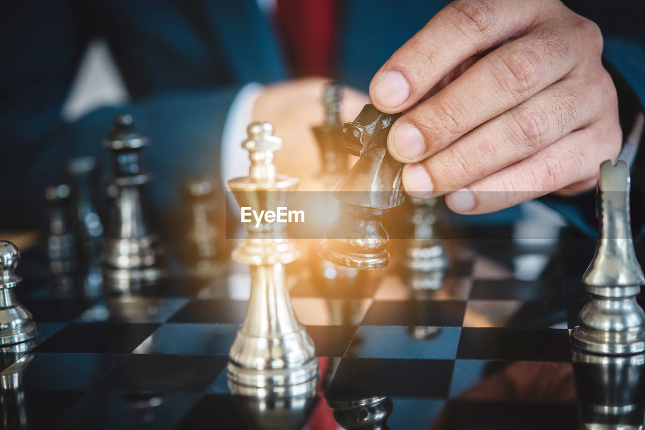 Close-up of businessman playing chess