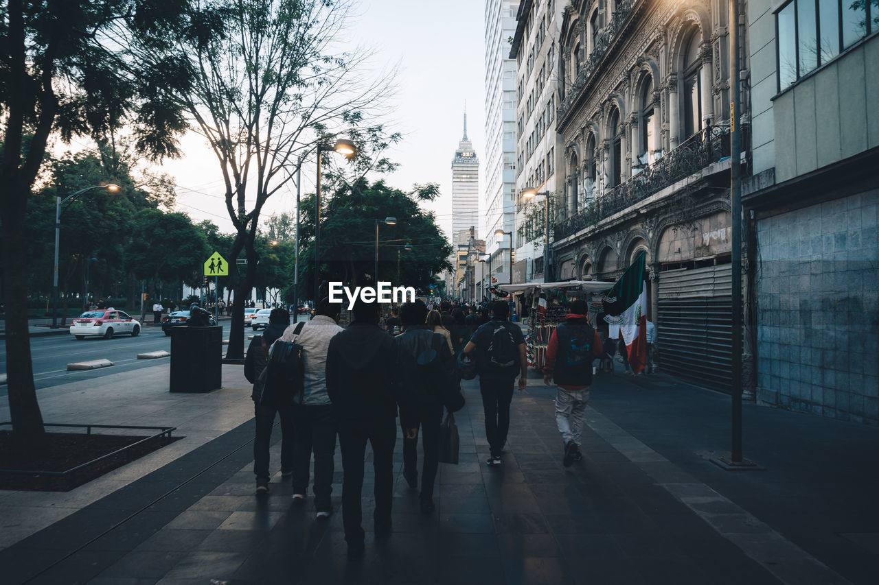 GROUP OF PEOPLE WALKING ON CITY STREET