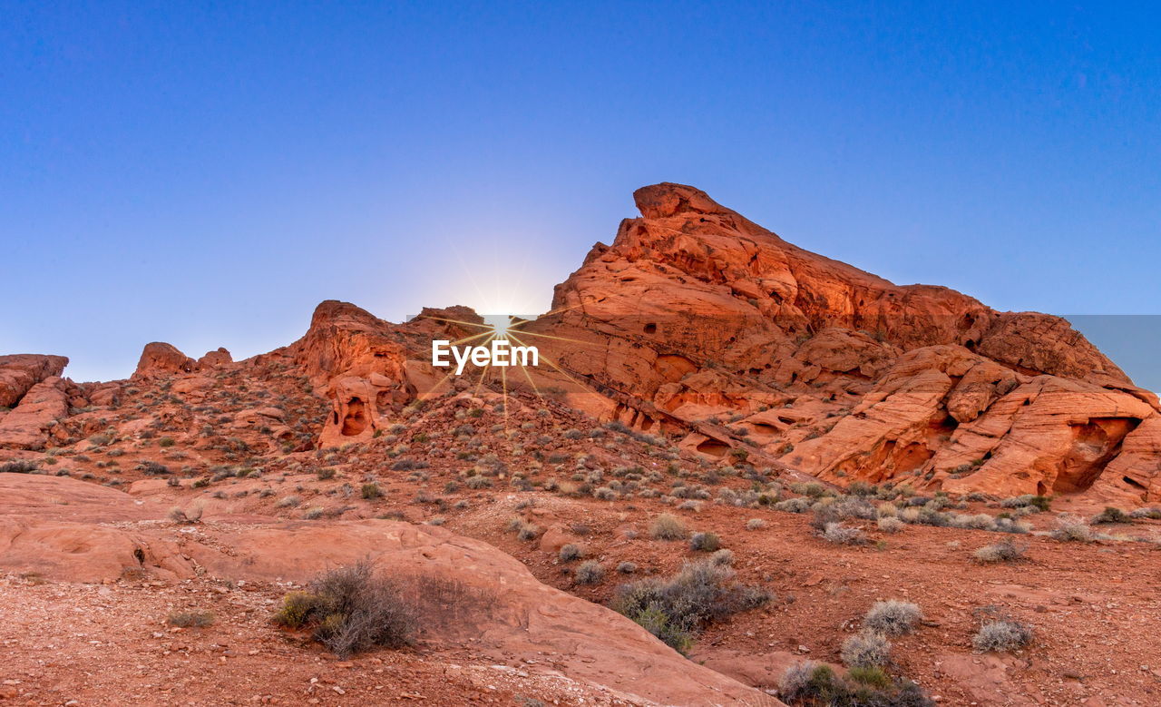 ROCK FORMATIONS AGAINST CLEAR BLUE SKY