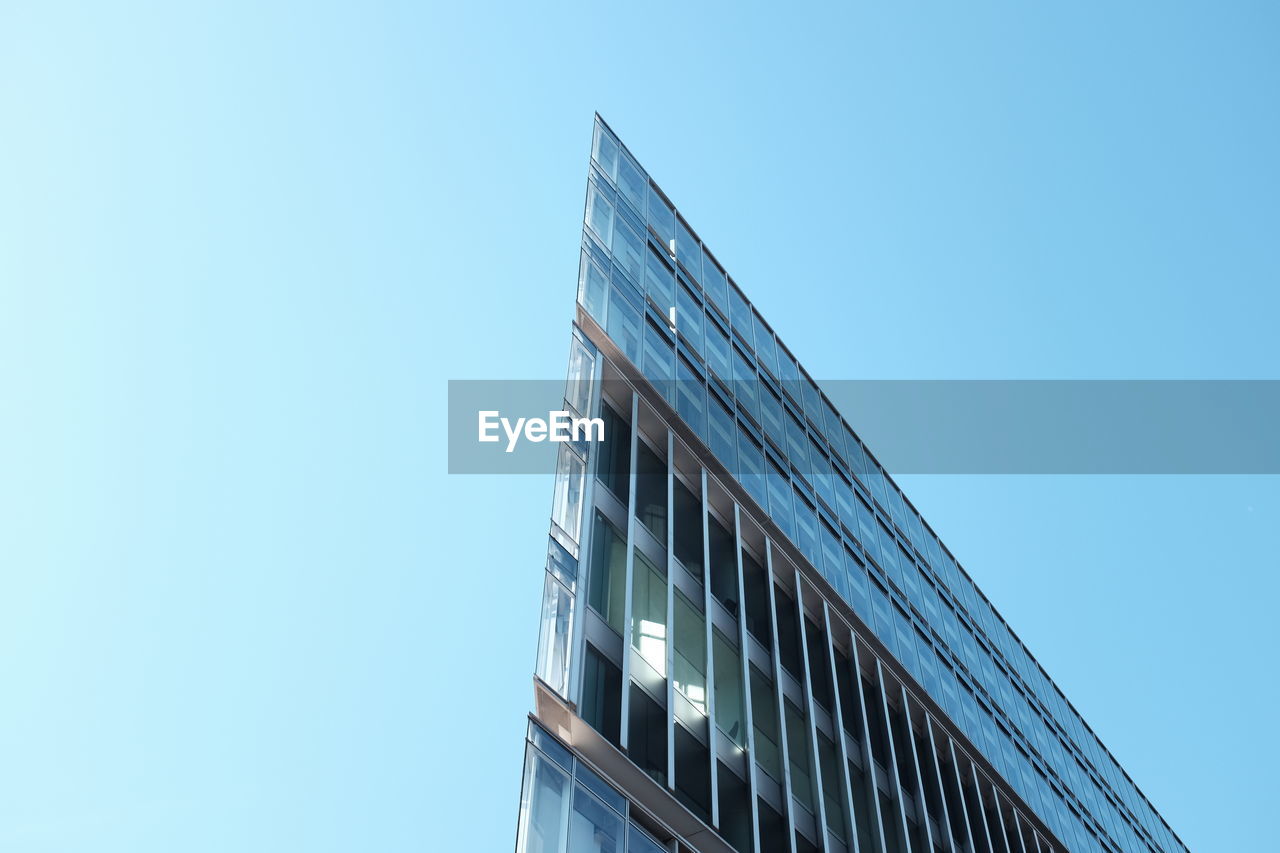 LOW ANGLE VIEW OF SKYSCRAPERS AGAINST BLUE SKY