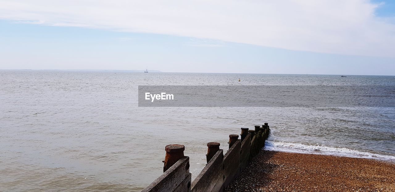 WOODEN POSTS ON SEA