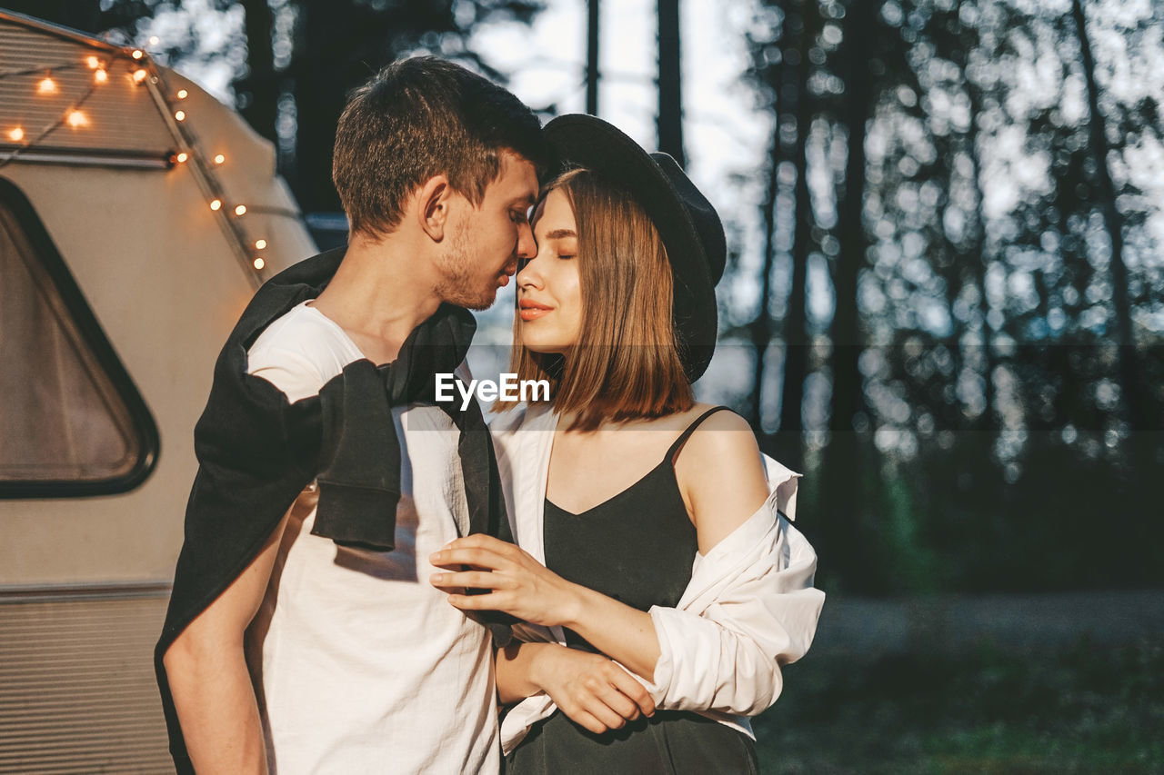 Close-up of couple embracing in forest