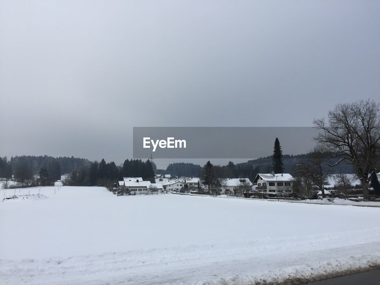 SNOW ON FIELD AGAINST SKY