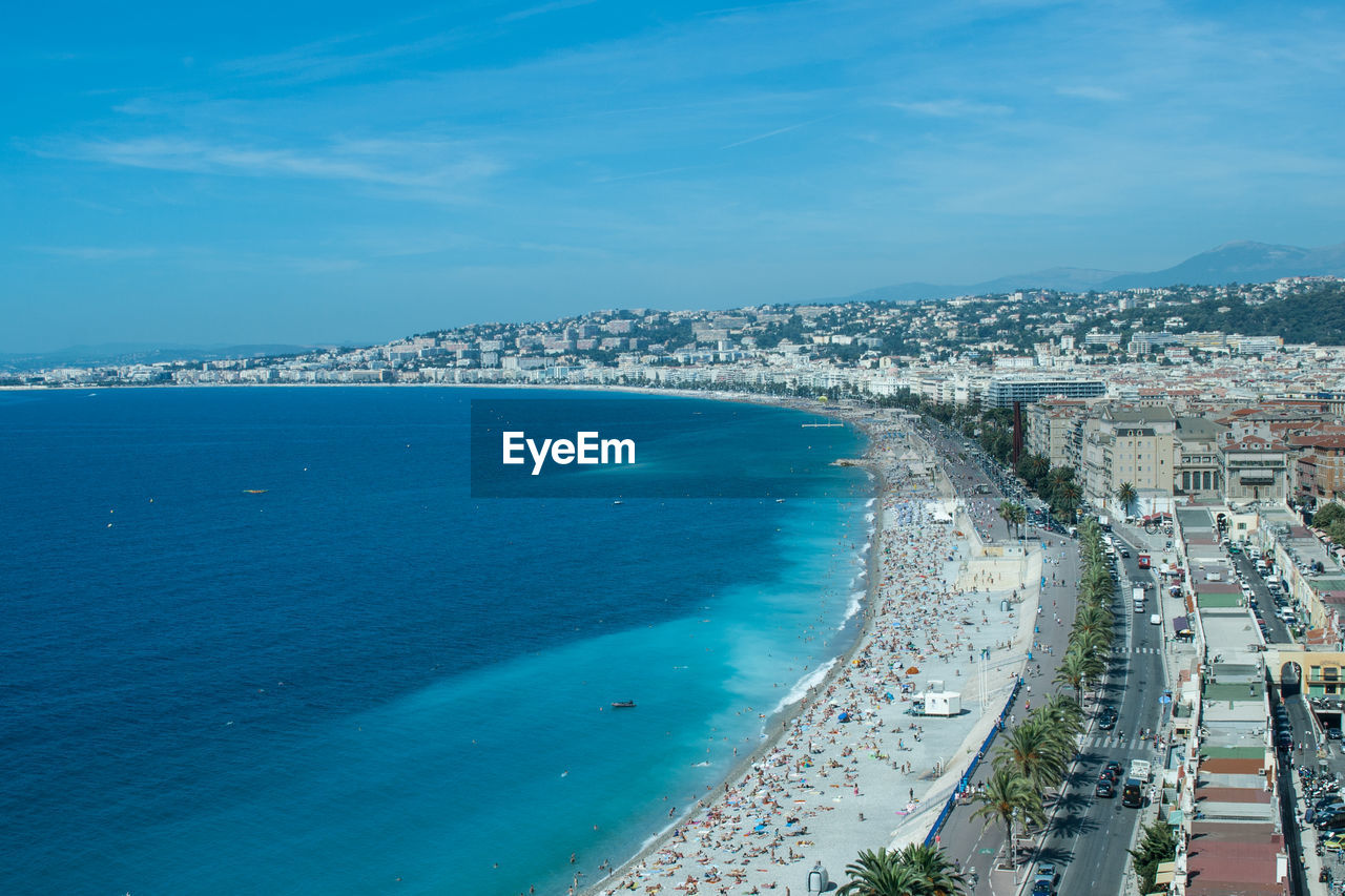 HIGH ANGLE VIEW OF SEA AND BUILDINGS IN CITY