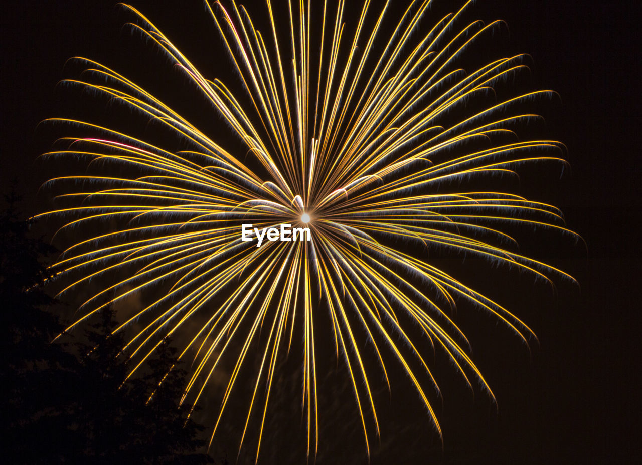 LOW ANGLE VIEW OF FIREWORKS IN SKY AT NIGHT