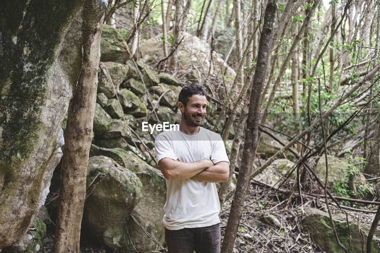 Upper part portrait of rock climber in a forest