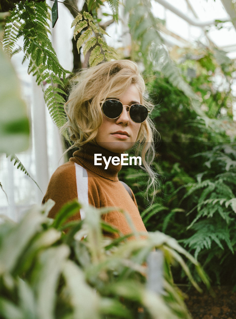 Portrait of a young woman in a botanical garden