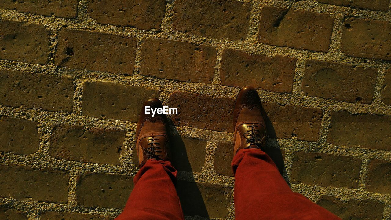 Low section of man standing on footpath