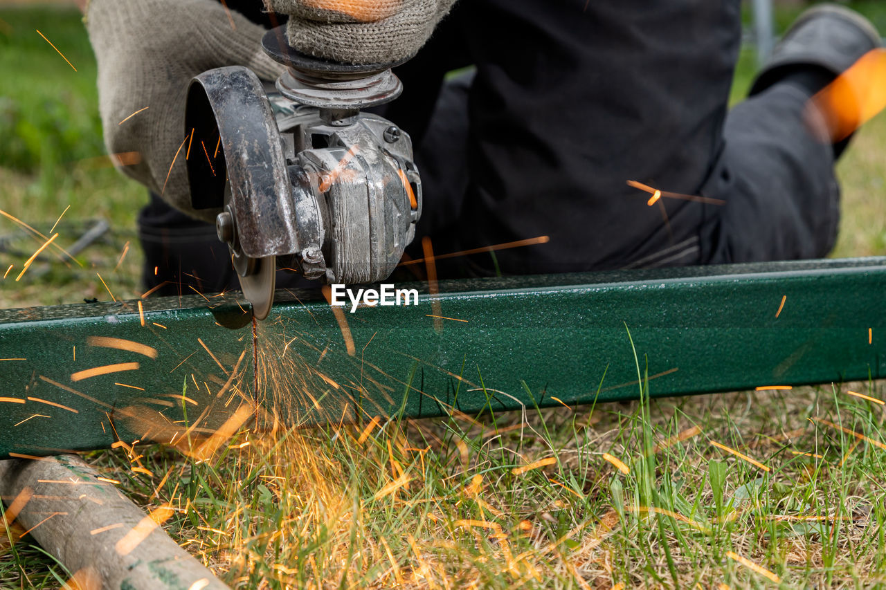 LOW SECTION OF MAN WORKING AT FIELD