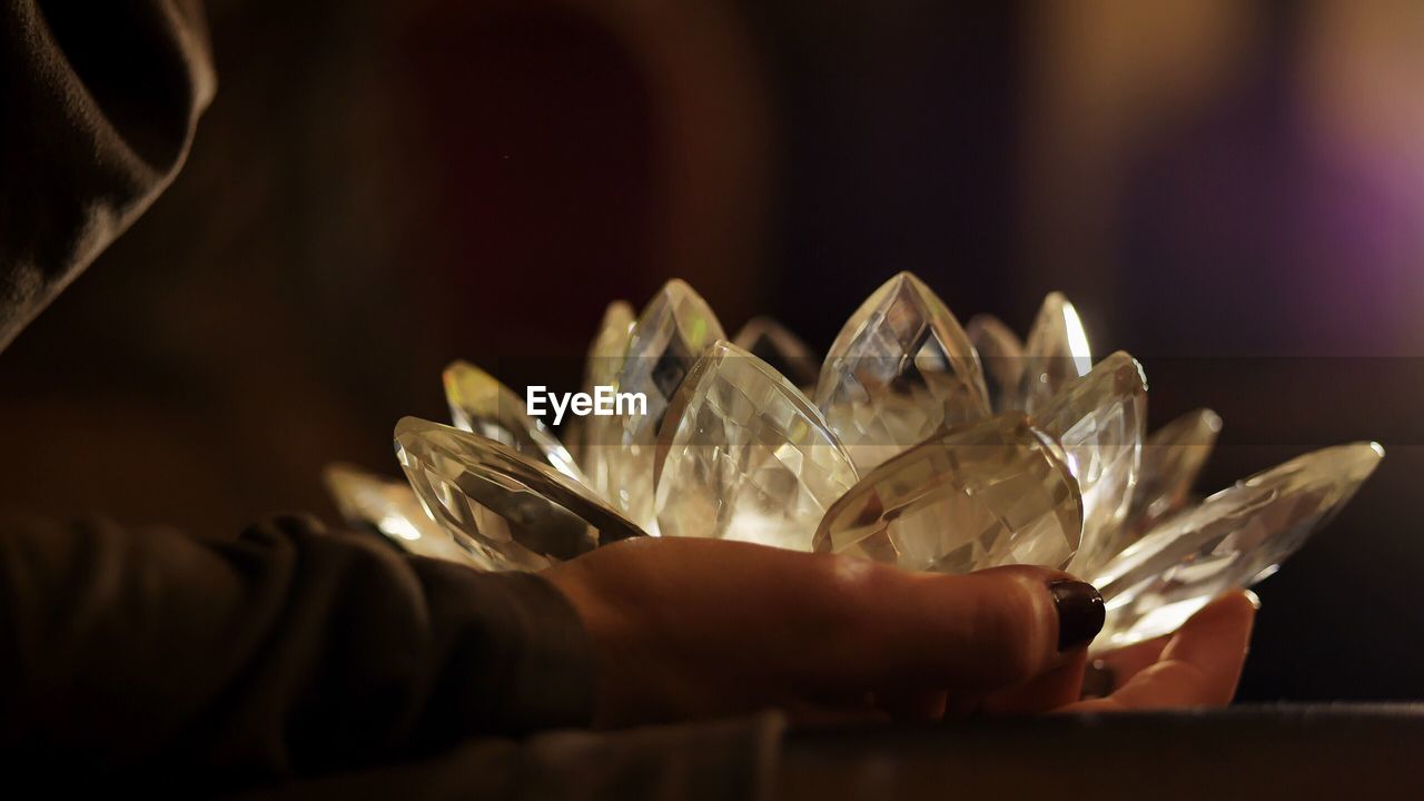 Close-up of hand holding crystal decor