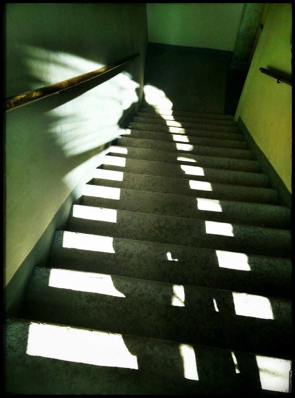 High angle view of shadow of person on stairs