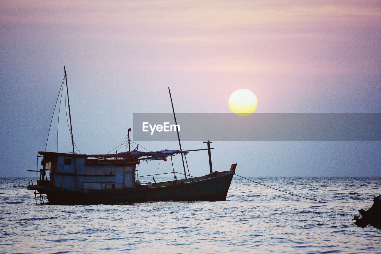 SHIP IN SEA AGAINST SKY DURING SUNSET