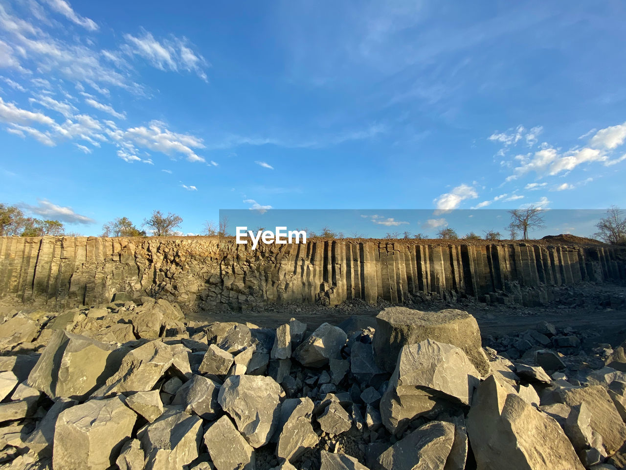 Panoramic view of rocks on land rock site against sky