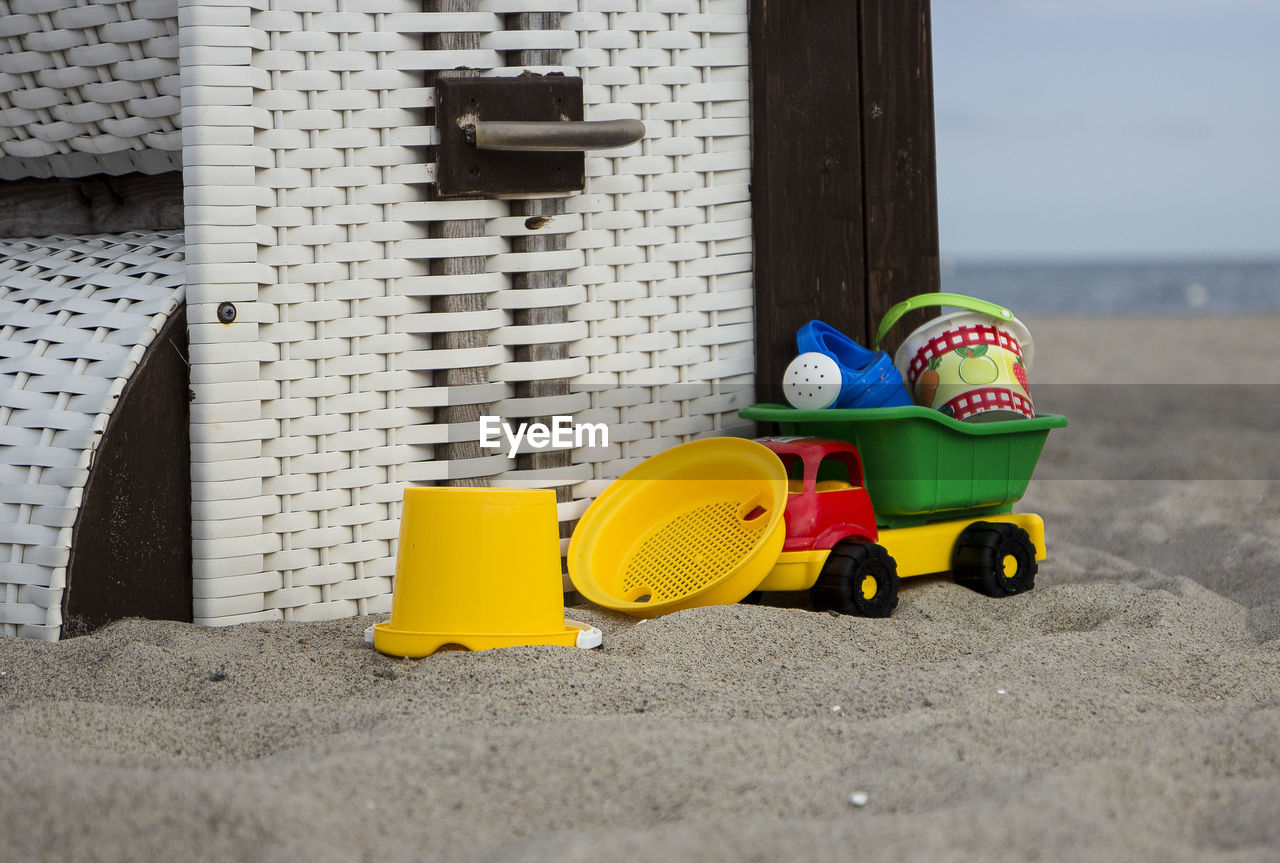 CLOSE-UP OF MULTI COLORED TOY CAR ON STONE