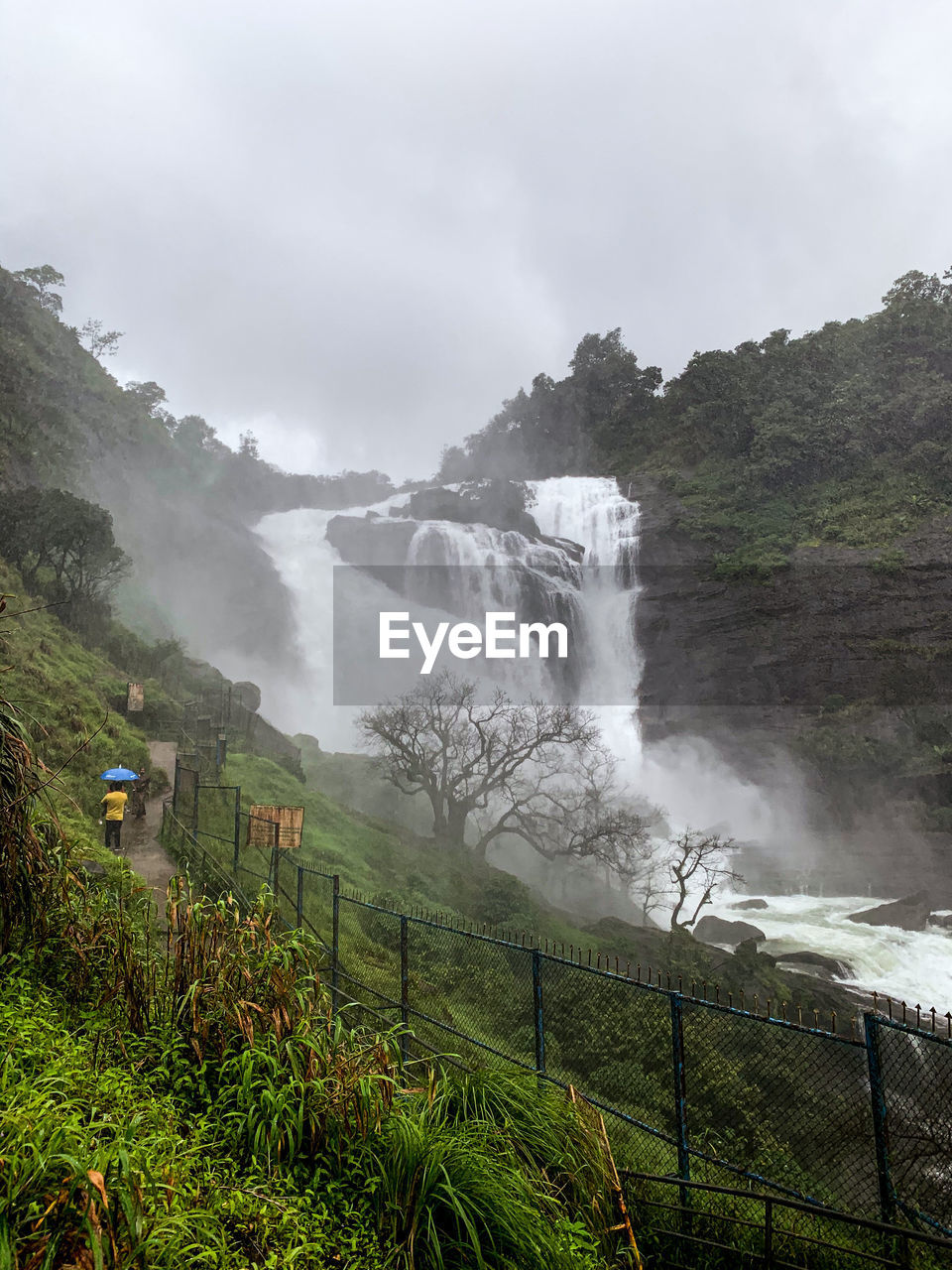 SCENIC VIEW OF WATERFALL AGAINST SKY DURING FOGGY WEATHER