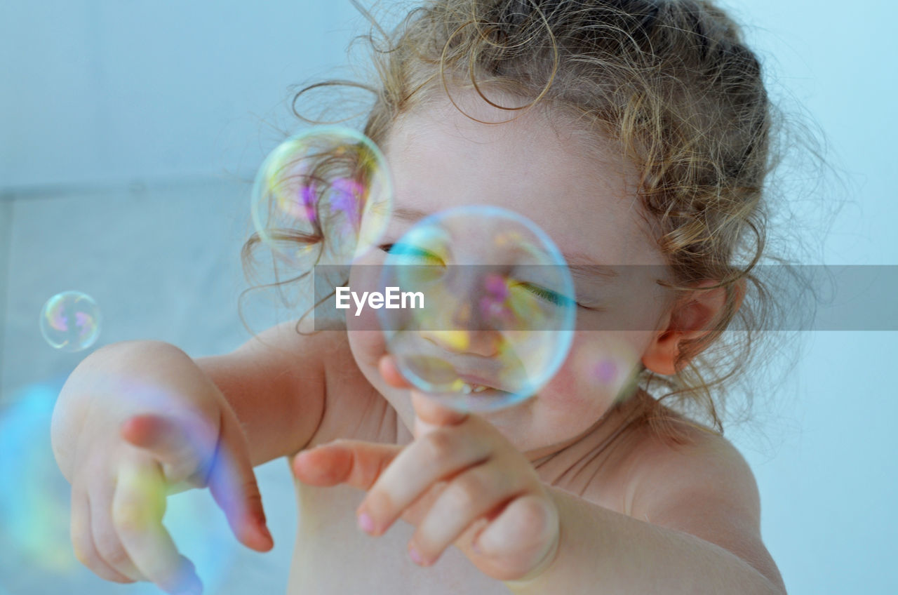 Close-up portrait of girl with bubbles