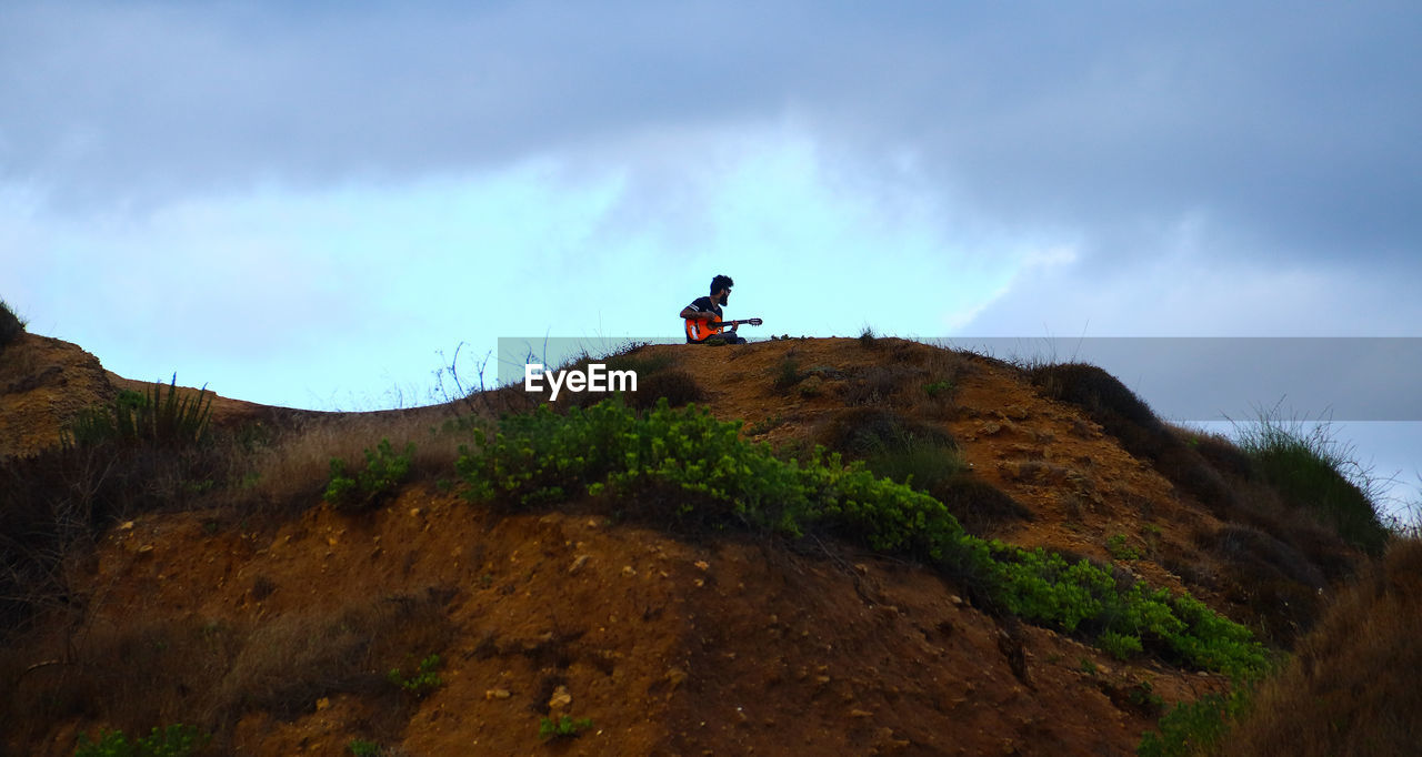 MAN STANDING ON LAND