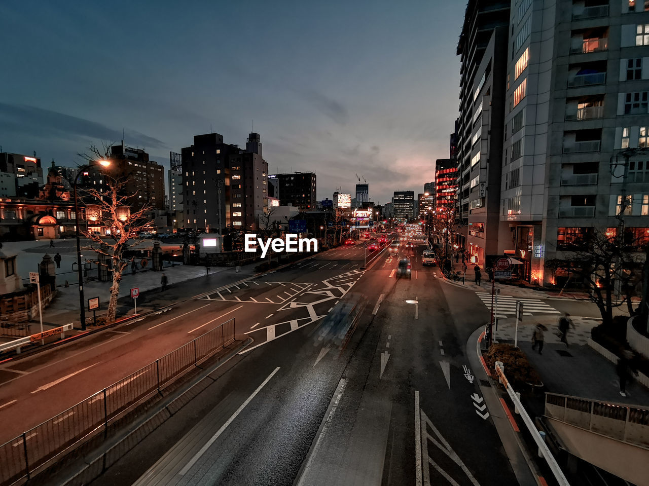 View of city street and buildings at night