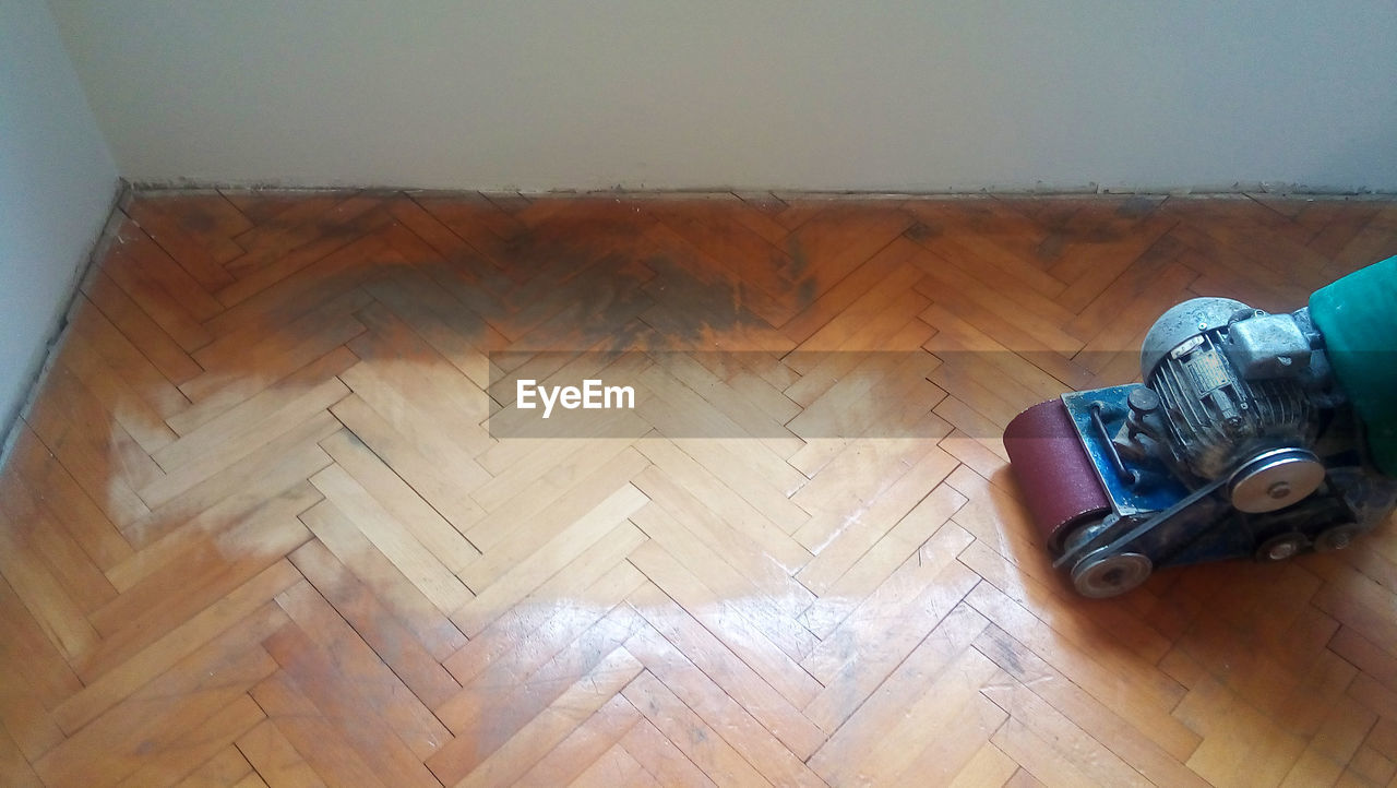 High angle view of machinery on hardwood floor at home