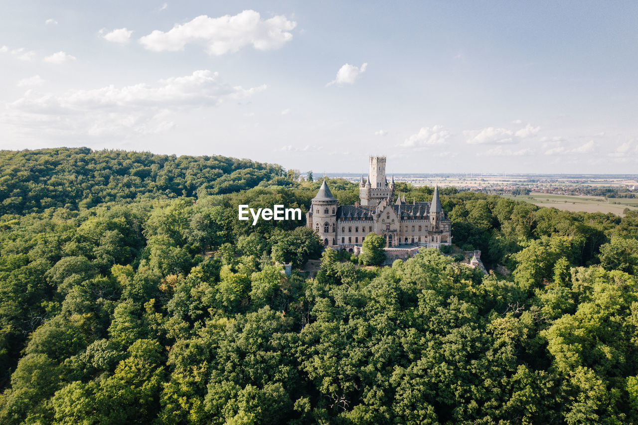 Marienburg castle amidst trees against sky