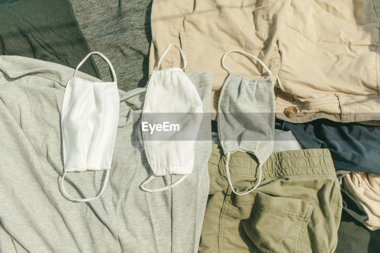 Hygienic mask and clothes being dried on hot sun to kill virus.