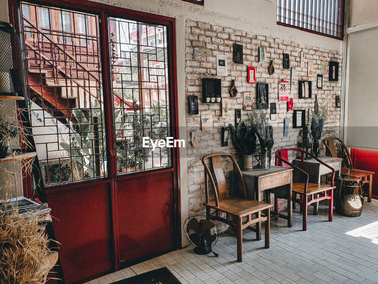 EMPTY CHAIRS AND TABLES AGAINST BUILDING