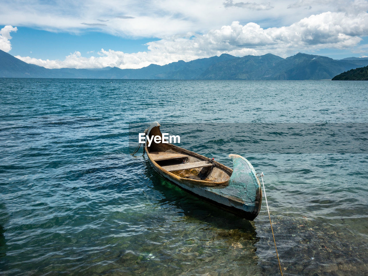 Boat moored on sea against sky