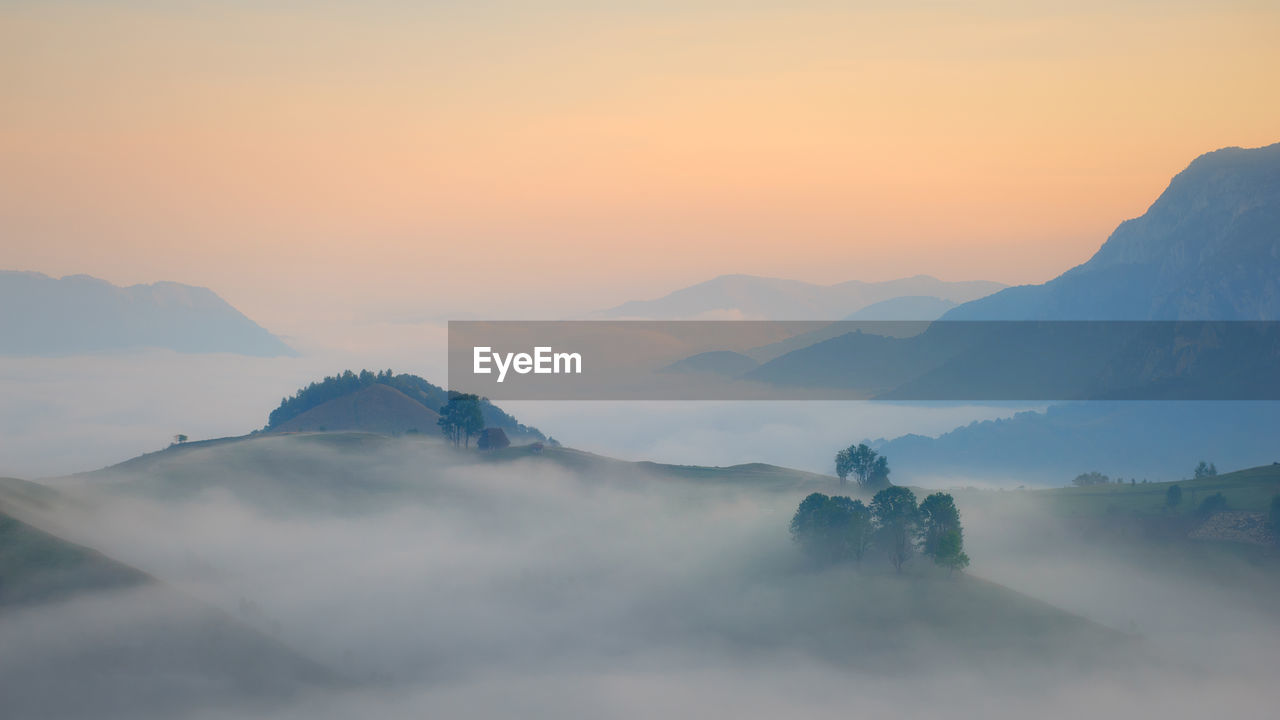 SCENIC VIEW OF MOUNTAINS DURING SUNSET