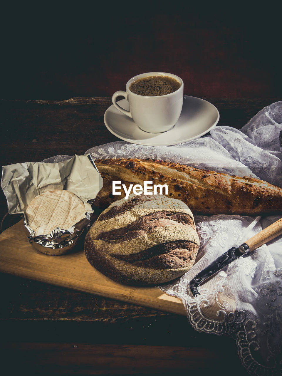 HIGH ANGLE VIEW OF COFFEE CUP WITH SPOON AND TABLE