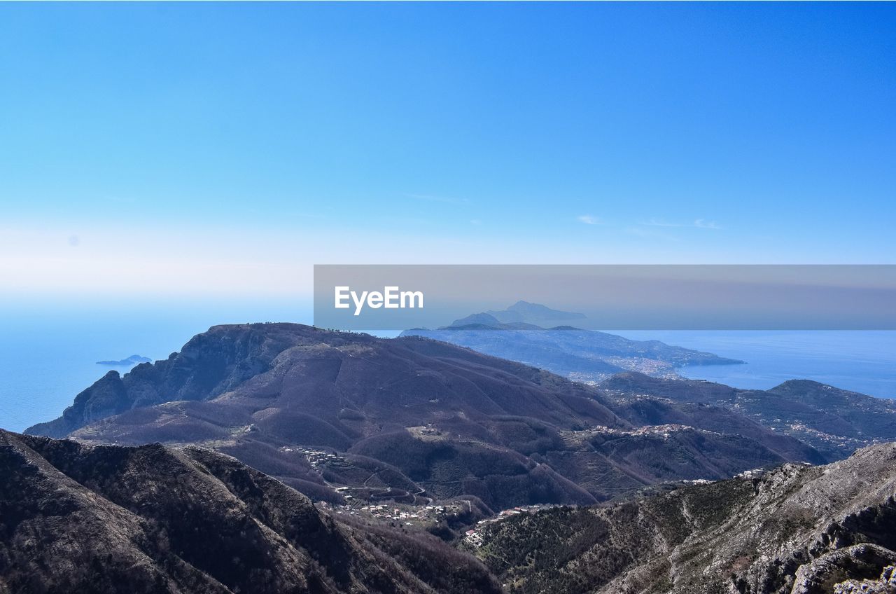 Scenic view of mountains against clear blue sky